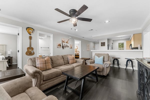 Champions living room with dark floors and guitar